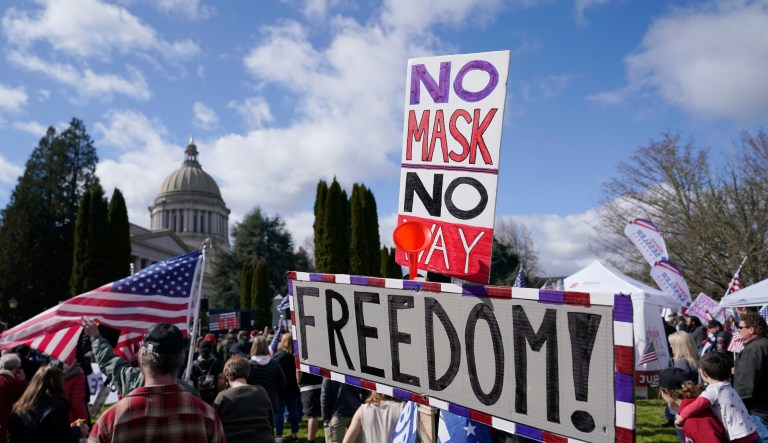 People hold signs that read âNo Mask, No Way