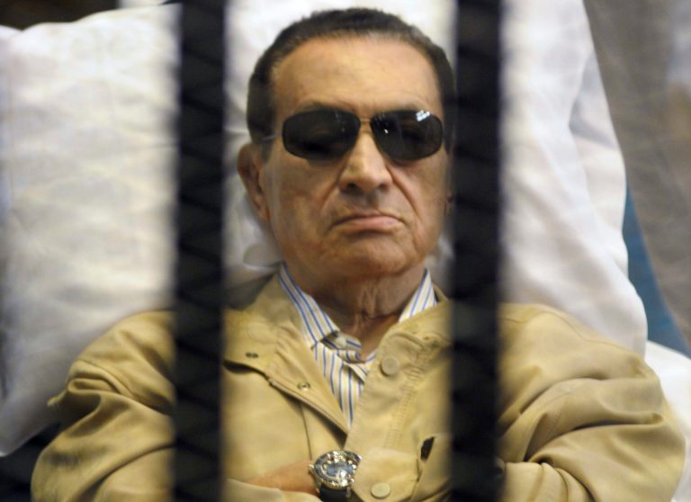   FILE - In this Saturday, June 2, 2012 file photo, Egypt's ex-President Hosni Mubarak lays on a gurney inside a barred cage in the police academy courthouse in Cairo, Egypt. Doctors used a defibrillator twice on Hosni Mubarak when they could not find a pulse Monday, the latest health crisis for the ousted Egyptian president since he was sentenced to life and moved to a prison hospital nine days ago, security officials said. In his last public appearance at his June 2 sentencing, the bedridden Mubarak sat stone-faced in the defendants' cage in the courtroom, his eyes hidden behind dark glasses. Officials said he broke into tears when he learned he was being transferred to a prison. (AP Photo, File)  