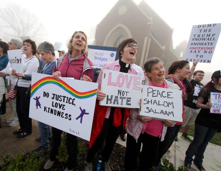 Protesters sing hymns during a Donald Trump rally in Hickory, N. C. (AP Photo/Ben Earp)