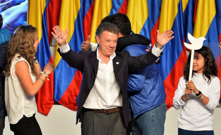 President Juan Manuel Santos celebrates his victory in the presidential runoff at his campaign headquarters in Bogota, Colombia, Sunday, June 15, 2014. Santos defeated challenger Oscar Ivan Zuluaga, of the Democratic Center, and won a second four-year term. (AP Photo/Santiago Cortez)