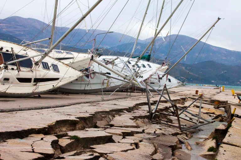 Yachts  are seen knocked off their stands at a damaged dock after an earthquake in Lixouri  on the island of Kefalonia, western Greece on Monday, Feb. 3, 2014. A strong earthquake with a preliminary magnitude between 5.7 and 6.1 hit the western Greek island of Kefalonia before dawn Monday, sending scared residents into the streets just over a week after a similar quake damaged hundreds of buildings, reviving memories of a disaster in the 1950s. (AP Photo)