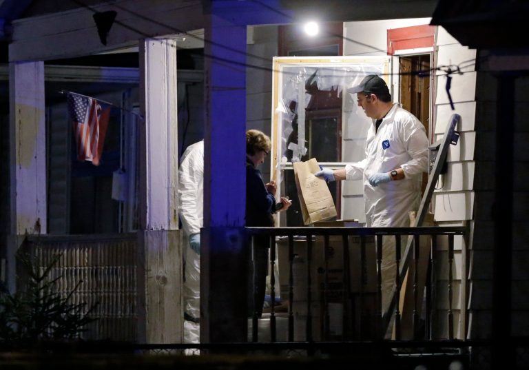 Members of the FBI evidence team remove items from a house on in Cleveland Monday, May 6, 2013. Three women who went missing separately about a decade ago, when they were in their teens or early 20s, were found alive in the house, and a man was arrested. (AP Photo/Mark Duncan)