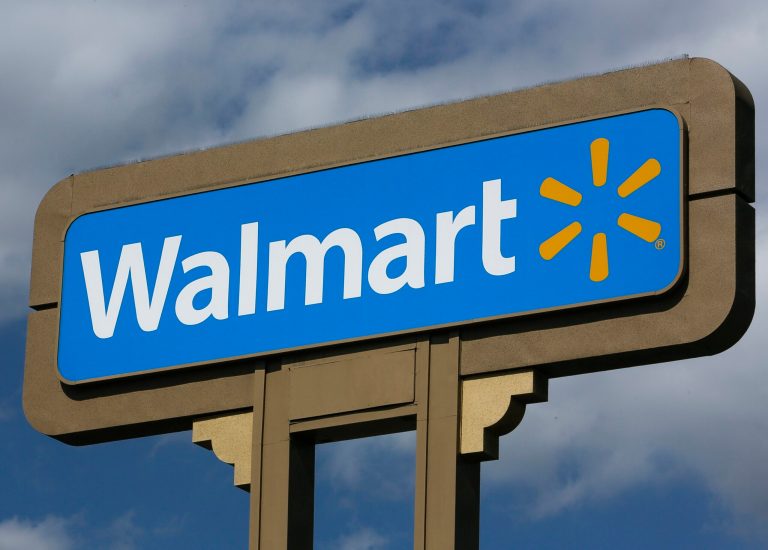 FILE - This May 28, 2013, file photo, shows a sign outside a Wal-mart store in Duarte, Calif. Wal-Mart on Wednesday, Sept. 24, 2014 said it is launching a mobile checking account for its customers that will eliminate some of the fees charged by banks. (AP Photo/Damian Dovarganes, File)