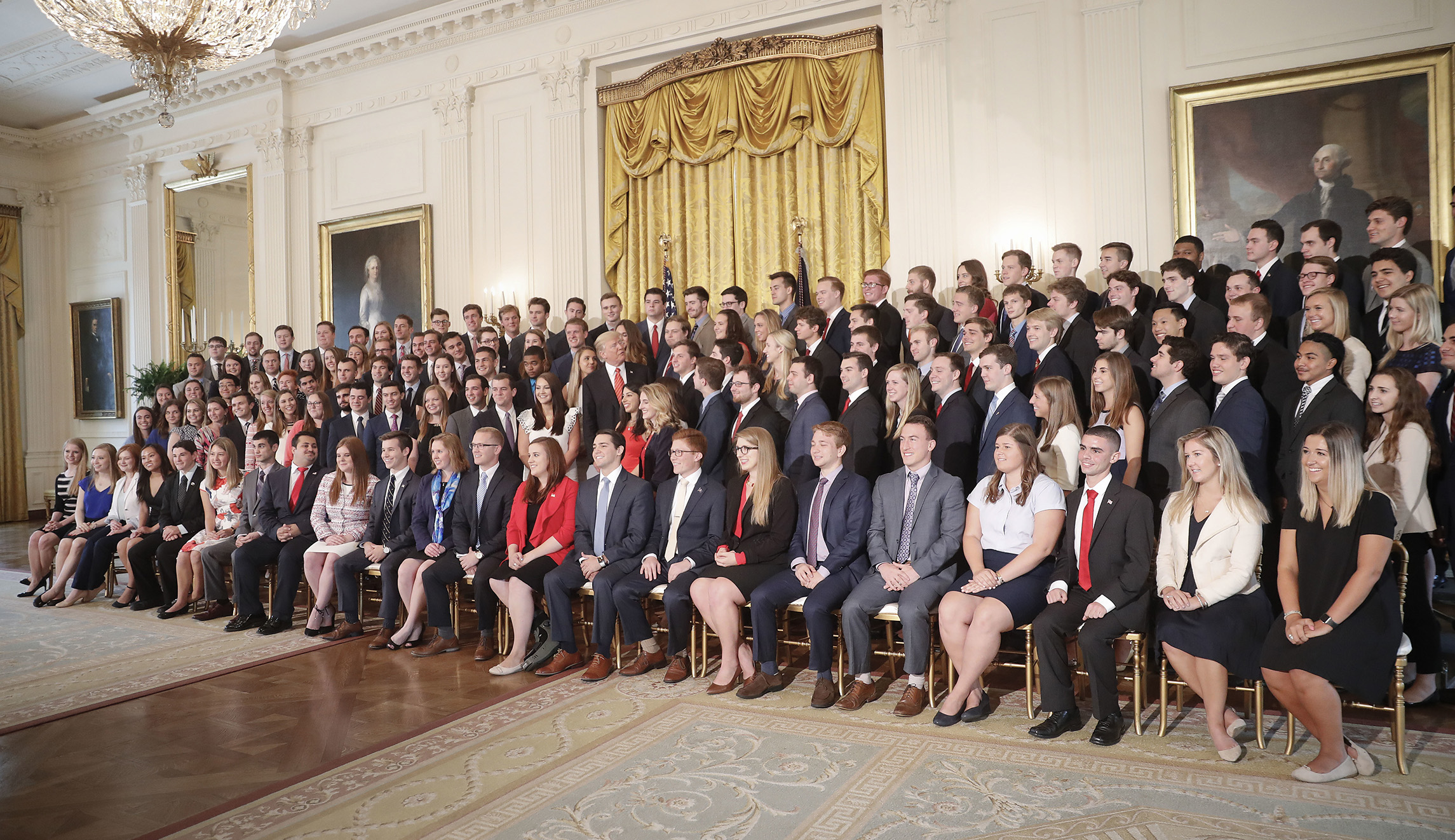 White House intern denies making white power sign in photo with Trump
