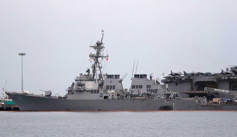 Divers located the remains of some missing American sailors in flooded compartments of the USS John S. McCain, a Navy destroyer that collided with an oil tanker in the Strait of Malacca on Monday. (AP Photo/Wong Maye-E)