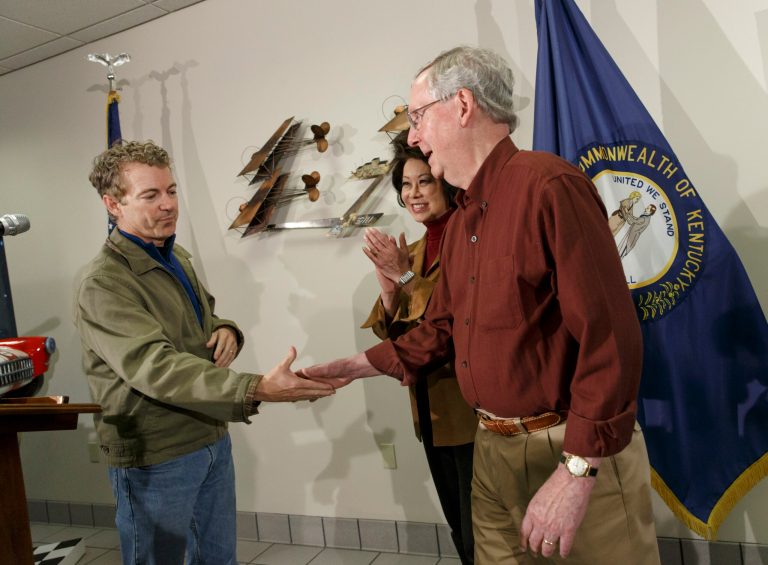 Senate Minority Leader Mitch McConnell, R-Ky., joined by his wife, former Labor Secretary Elaine Chao, gets a campaign assist from Sen. Rand Paul, R-Ky., left, at the Warren County Regional Airport in Paul's hometown, Bowling Green, Ky., Monday, Nov. 3, 2014. (AP Photo/J. Scott Applewhite)