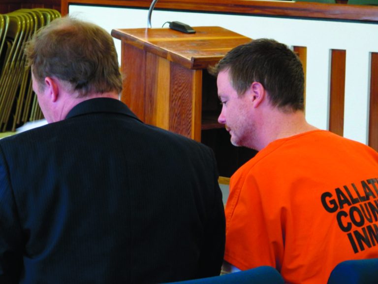 Jesse Paul Spee, right, goes over documents with attorney Eric Brewer in a court appearance Monday, Oct. 15, 2012, in Bozeman, Mont. Speer agreed to waive extradition to return to Wyoming to face kidnapping, aggravated assault and a weapons charge related to the kidnapping of an 11-year-old girl. (AP Photo/Matt Volz).
