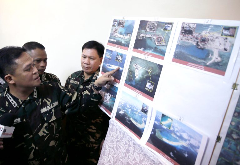 Armed Forces of the Philippines Chief of Staff Gen. Gregorio Pio Catapang points to reveal recent images of China's reclamation activities being done at the disputed islands in the South China Sea. (AP Photo)