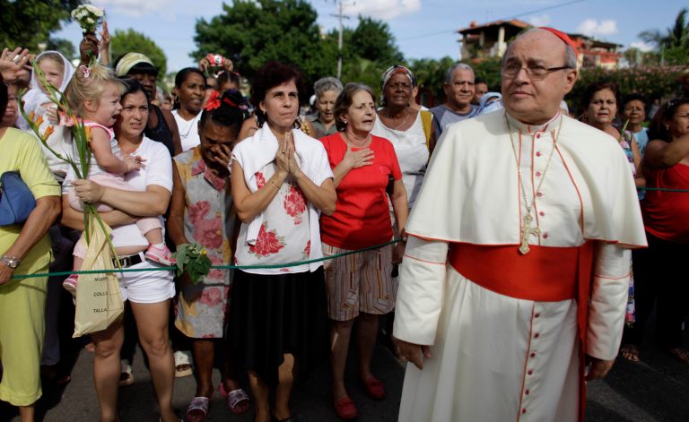   FILE - In this Nov. 10, 2011 file photo, Cuba's Cardinal Jaime Ortega attends a procession honoring the nation's patron saint, the Virgin of Charity of Cobre, in Havana, Cuba. For months, Ortega has been under fire: called a lackey and political ally of Raul Castro's communist government, asked to resign over his treatment of protesters and ridiculed in Miami as a snobby elitist. Church officials on the island have launched a full-throated defense of their leader, and Catholic publications have harshly denounced his critics. Analysts say the increasingly virulent back-and-forth is extremely unusual on an island where the church has traditionally preferred to exercise influence quietly, behind the scenes. (AP Photo/Javier Galeano, File)  