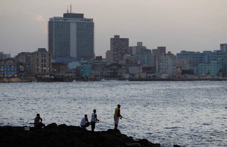 FILE - In this July 8, 2013 file photo, fishermen cast their lines along the Malecon in Havana, Cuba. The number of U.S. visitors to Cuba continues to rise, even as the more than five-decade long embargo remains firmly in place, according to study released Monday, April 7, 2014 by the U.S.-based Havana Consulting Group. (AP Photo/Franklin Reyes, File)