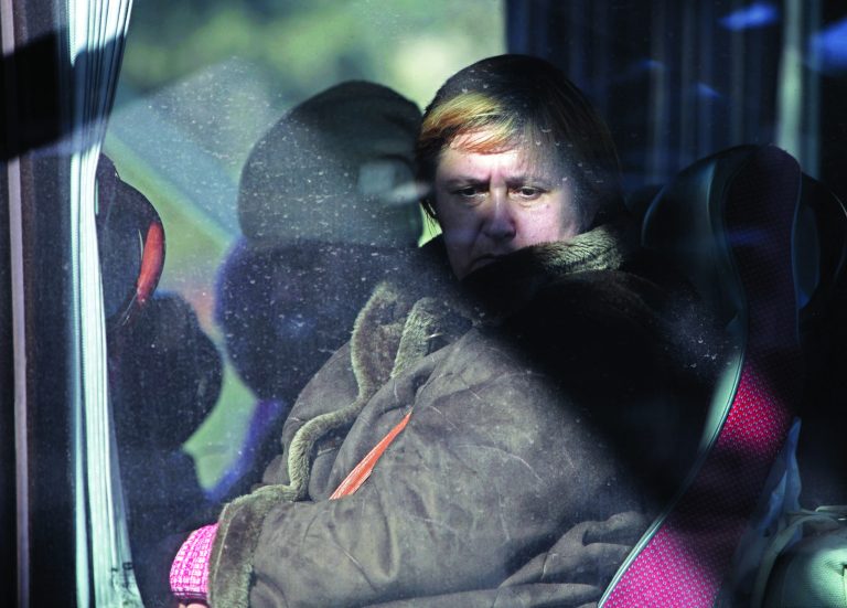 A Russian woman rides a bus shortly after crossing the border from Syria into Lebanon at the Masnaa border crossing in eastern Lebanon, Tuesday, Jan. 22, 2013. Some 80 Russian citizens crossed into Lebanon as Moscow began evacuating some of the tens of thousands of Russians who live in Syria. (AP Photo/Bilal Hussein)