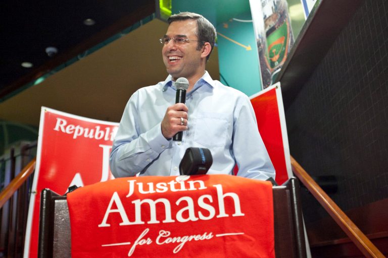 U.S. Rep. Justin Amash celebrates his primary election victory over Brian Ellis at GP Sports inside the Amway Grand Plaza Hotel in downtown Grand Rapids Tuesday, Aug. 5, 2014. (AP Photo/The Grand Rapids Press, Cory Morse)