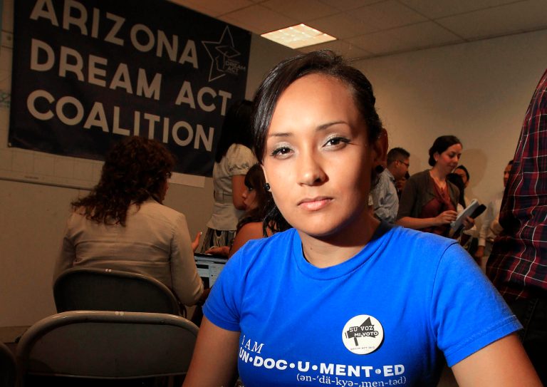 FILE - In this Aug. 15, 2012, file photo, young immigrant Erika Andiola, of Mesa, Ariz., poses for a photo at a site where people line up for guidance on the new federal program, called Deferred Action, that would help them avoid deportation in Phoenix. Andiola's mother and a brother were arrested on Jan. 10, 2013, at the family's Phoenix-area home. After coming out of the shadows and organizing on their own to advocate for immigration relief, many young immigrants known as dreamers are taking sides with political parties and working or volunteering for presidential campaigns. (AP Photo/Ross D. Franklin, File)