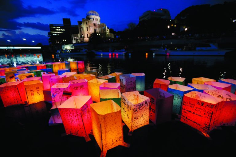 Paper lanterns float along the Motoyasu River in front of the illuminated Atomic Bomb Dome in Hiroshima, western Japan, Monday, Aug. 6, 2012. Hiroshima marks the 67th anniversary of the atomic bombing on Aug 6.(AP Photo/Itsuo Inouye)