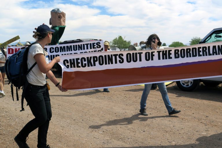Protesters carry a large banner as they walk toward a U.S. Border Patrol checkpoint on a two-lane road in Amado, Ariz. Sen. Jeff Sessions, R-Ala., wants voters to focus on immigration positions of candidates. (AP Photo/Astrid Galván, File )
