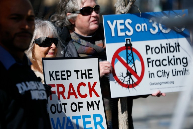 The protesters appeared to be part of a campaign started by the Center for Biological Diversity to point out the hypocrisy of state officials who support taking climate action, but back natural gas development from shale. (AP Photo)