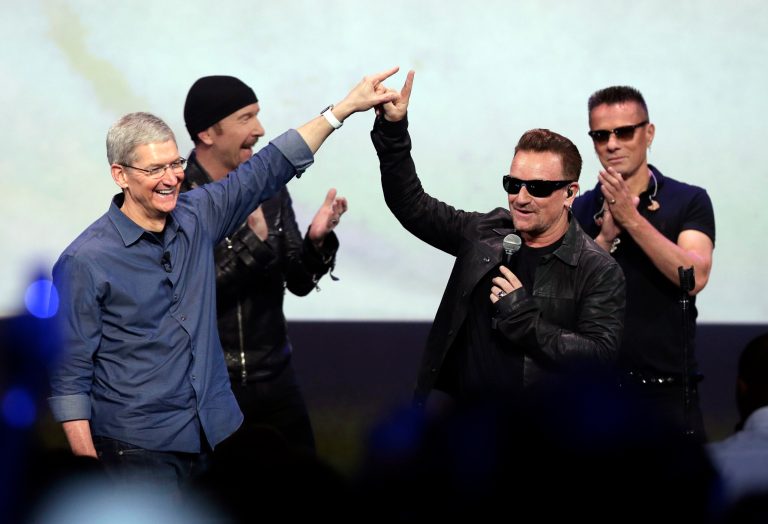 FILE - In this Sept. 9, 2014 file photo, Apple CEO Tim Cook, left, greets Bono from the band U2 after they preformed at the end of the Apple event on Tuesday, Sept. 9, 2014, in Cupertino, Calif. Apple unveiled a new Apple Watch, the iPhone 6 and Apple Pay and U2 offered iTunes customers a free download of their latest album, 