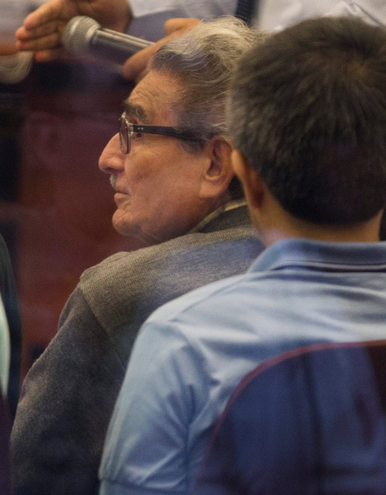 Abimael Guzman, founder and leader of the Shining Path guerrilla movement, second from the right, sits during his new trial at the Naval Base in Callao, Peru, Monday, Jan. 20, 2014. Guzman and several more defendants are being tried for the 1992 Tarata street bombing, wich killed scores, and injured hundreds more. (AP Photo/Martin Mejia)