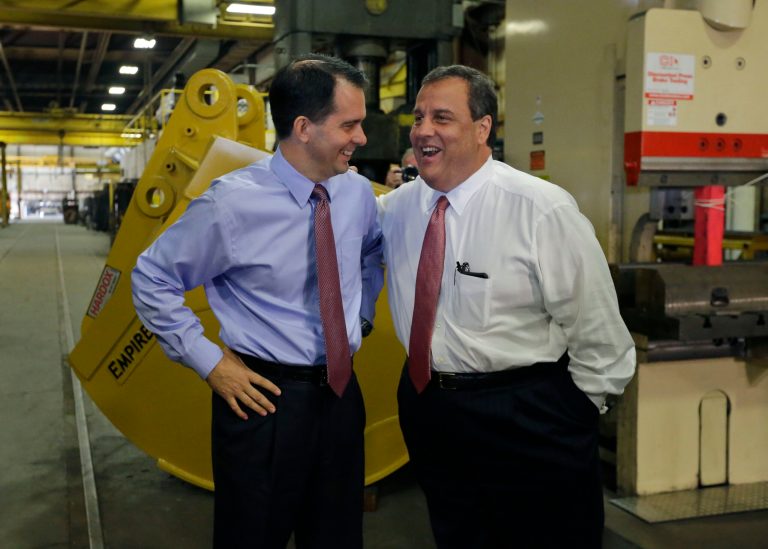 Christie, right, and Wisconsin Gov. Scott Walker share a laugh at a campaign stop in Hudson, Wis., on Monday. (AP/Ann Heisenfelt)