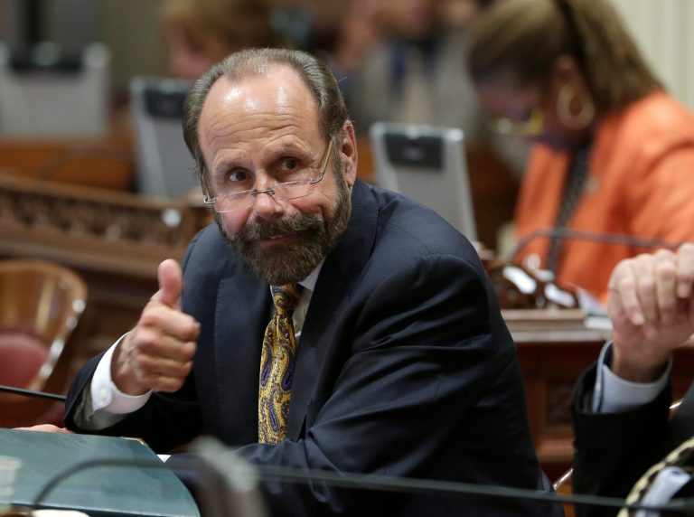 State Sen. Jerry Hill, D-San Mateo, gives a thumbs up to Sen. Bill Berryhill, R-Twain Harte, unseen, after he voted for Hill's campaign reform measure at the Capitol in Sacramento,Calif., Monday, June 9, 2014.  By a 35-1 vote the Senate approved Hill's SB831, that creates new disclosure laws for travel-related gifts and bans elected official from requesting payments be made on their  behalf to nonprofit organizations. (AP Photo/Rich Pedroncelli)