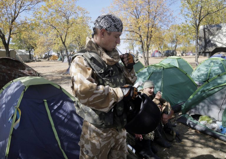 Ukrainian army paratroopers smoke cigarettes, at their position in Debaltsevo, Donetsk's region, Ukraine, Thursday, Sept. 18, 2014. The cease-fire between the separatists and the Ukrainian military in eastern Ukraine has largely held. (AP Photo/Efrrem Lukatsky)