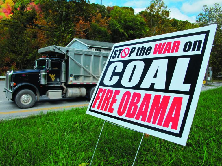 A truck passes a political sign in a yard in Dellslow, W.Va., on Oct. 16, 2012. Rhetoric about the administration's alleged 