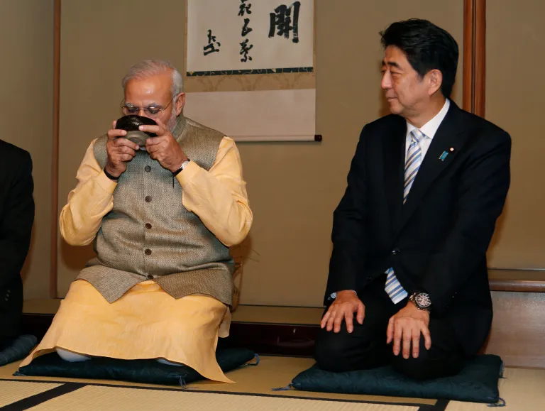 Japanese Prime Minister Shinzo Abe, right, watches Indian Prime Minister Narendra Modi drink a bowl of green tea during a tea ceremony at a tea hut of the Omotesenke, one of the main schools of Japanese tea ceremony, in Tokyo Monday, Sept. 1, 2014. Modi was on his official visit to Japan. (AP Photo/Yuya Shino, Pool)