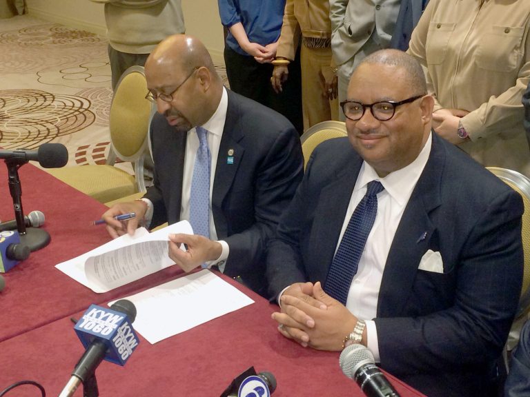 Philadelphia Mayor Michael Nutter, left, and District Council 47 President Frederick Wright prepare to sign the first new contract for the city's white-collar workers on Tuesday, Feb. 25, 2014. The contract ends a five-year stalemate and extends a new contract to mid-2017, Wright said Tuesday according to the Philadelphia Inquirer. (AP Photo/The Philadelphia Inquirer, Troy Graham)  
