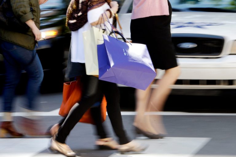 FILE - In this Wednesday, Sept. 18, 2013, file photo, pedestrians with shopping bags cross a street in Philadelphia. The Federal Reserve releases consumer credit data for August on Monday, Oct. 7, 2013. (AP Photo/Matt Rourke, File)