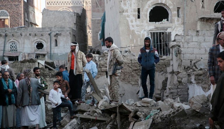 People stand on the rubble of houses at the site of a Saudi-led airstrike near Yemen's Defense Ministry complex in Sanaa, Yemen, Saturday, Nov. 11, 2017. (AP Photo/Hani Mohammed)