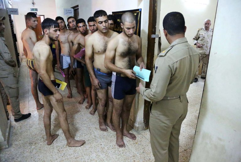 Iraqi men line up for physical examinations at the main army recruiting center to volunteer for military service in Baghdad, Iraq, Tuesday, June 24, 2014, after authorities urged Iraqis to help battle insurgents. Political leaders have agreed to start the process of seating a new government by July 1. Once a stable government is in place, officials hope Iraqi security forces will be inspired to fight the insurgency instead of fleeing, as they did in several major cities and towns in Sunni-dominated areas since the start of the year.(AP Photo/Karim Kadim)