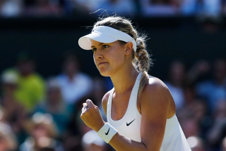 Eugenie Bouchard of Canada celebrates after winning the first set as she plays against Simona Halep of Romania during their womenâs singles semifinal match at the All England Lawn Tennis Championships in Wimbledon, London, Thursday, July 3, 2014. (AP Photo/Ben Curtis)