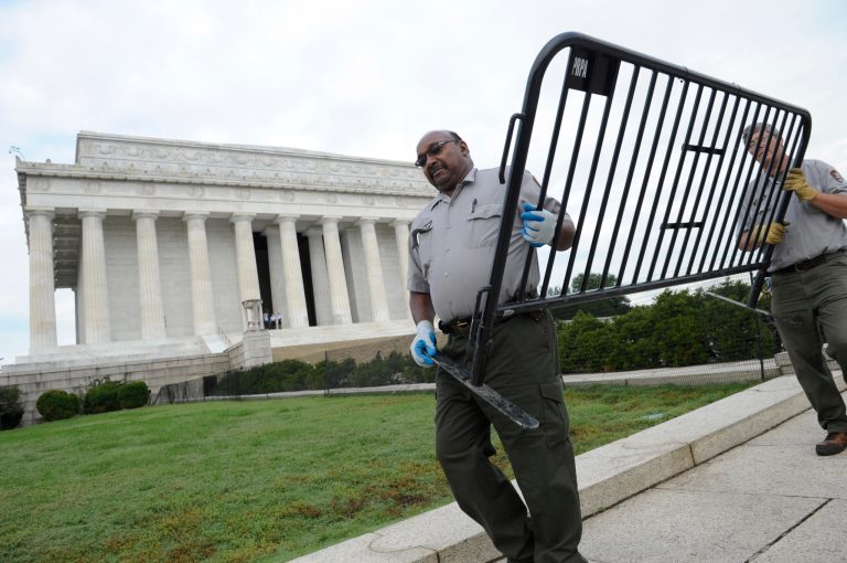 National Park Service employees remove barricades from the grounds of the Lincoln Memorial in Washington, Thursday, Oct. 17, 2013. Barriers went down at National Park Service sites and thousands of furloughed federal workers began returning to work throughout the country Thursday after 16 days off the job because of the partial government shutdown.(AP Photo/Susan Walsh)