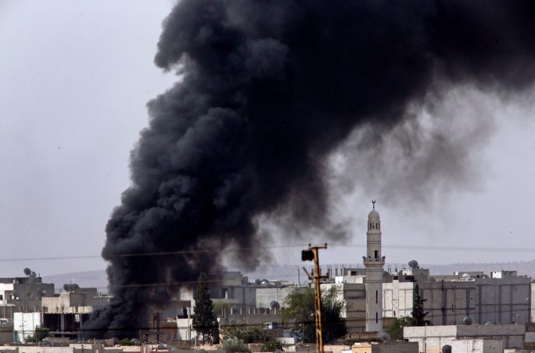 Heavy smoke from a fire caused by a strike rises in Kobani, Syria as fighting intensified between Syrian Kurds and the militants of Islamic State group, as seen from Mursitpinar in the outskirts of Suruc, at the Turkey-Syria border, Friday, Oct. 10, 2014. Kobani, also known as Ayn Arab, and its surrounding areas, has been under assault by extremists of the Islamic State group since mid-September and is being defended by Kurdish fighters. (AP Photo/Lefteris Pitarakis)