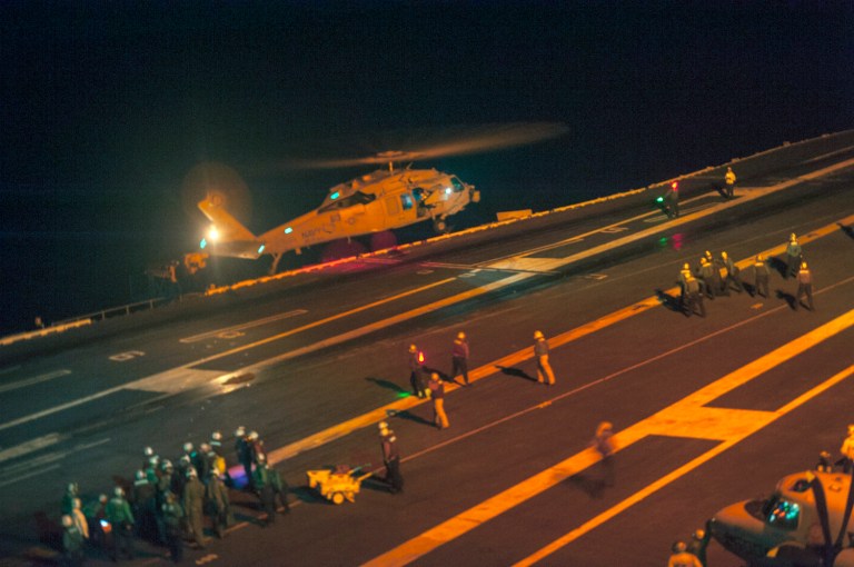 An MH-60S Sea Hawk helicopter lands on the flight deck of the Nimitz-class aircraft carrier USS Carl Vinson (CVN 70) during search and rescue operations for a missing pilot on on Friday. (AP Photo/US Navy, MCS 2nd Class John Philip Wagner Jr.)