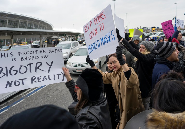 Protesters assemble at John F. Kennedy International Airport in New York, Saturday, Jan. 28, 2017 after two Iraqi refugees were detained while trying to enter the country. (AP Photo/Craig Ruttle)