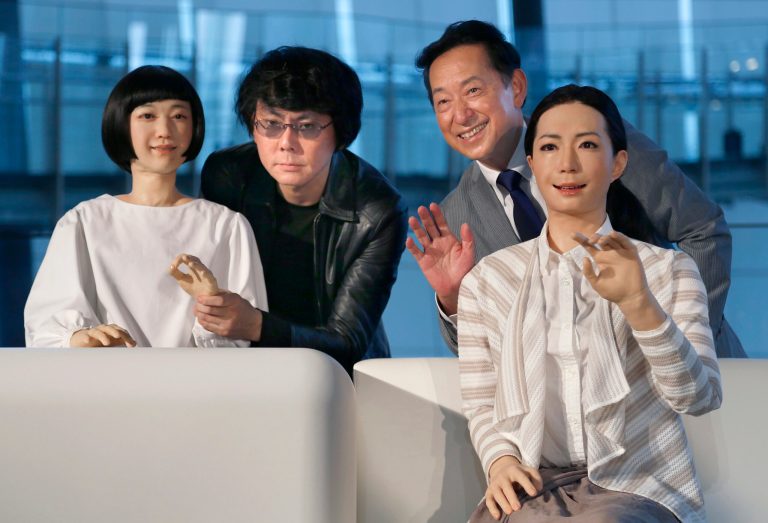 Japanese android expert Hiroshi Ishiguro, second left, and National Museum of Emerging Science and Innovation Miraikan Chief Executive Director Mamoru Mohri, second right, pose with a female-announcer robot called Otonaroid, right, and a girl robot called Kodomoroid during a press unveiling of the museum's new guides in Tokyo Tuesday, June 24, 2014. The latest creations from Osaka University Prof. Ishiguro are the Otonaroid, the Kodomoroid and Telenoid, a hairless mannequin head with pointed arms that serves as a cuddly companion. The robots with silicon skin and artificial muscles were shown to reporters at Miraikan museum on Tuesday. (AP Photo/Shizuo Kambayashi)