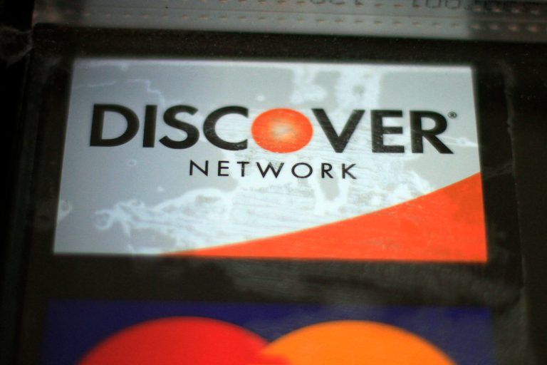 In this Tuesday, Jan. 21, 2014, photo a Discover sign hangs on the door of a business in Robinson Township, Pa. Discover reports quarterly earnings on Thursday, Jan. 23, 2014. (AP Photo/Gene J. Puskar)