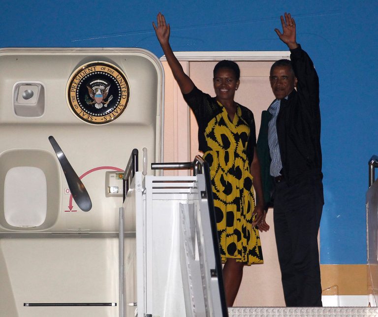 President Barack Obama and first lady Michelle Obama wave as they board Air Force One at the Cape Cod Coast Guard Station in Bourne, Mass., Sunday, Aug. 24, 2014, en route to Washington. (AP Photo/Stew Milne)