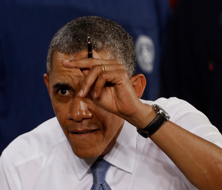 President Barack Obama prepares to sign a document after speaking at General Electric's Waukesha, Wis. gas engine plant, Thursday, Jan. 30, 2014. The trip is part of a four-stop tour President Barack Obama is making to expand themes from his State of the Union address. (AP Photo/Jeffrey Phelps)