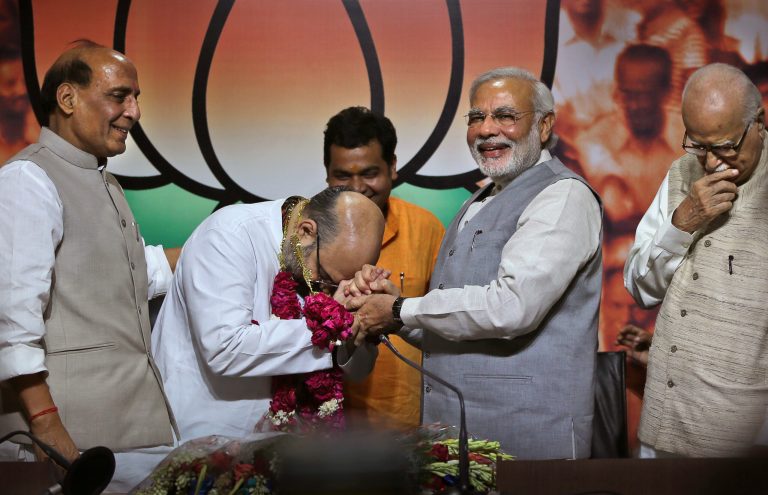 Indian Prime Minister Narendra Modi, second right, greets newly appointed Bharatiya Janata party or BJP president Amit Shah, second left, as outgoing party president Rajnath Singh, left, and BJP senior leader L.K.Advani look on, at party headquarters in New Delhi, India, Wednesday, July 9, 2014. Shah, a close aide of Prime Minister Narendra Modi has been appointed chief of Indiaâs ruling Bharatiya Janata Party. Shah replaces Rajnath Singh who was recently sworn in as home minister in Modiâs cabinet. (AP Photo /Manish Swarup)