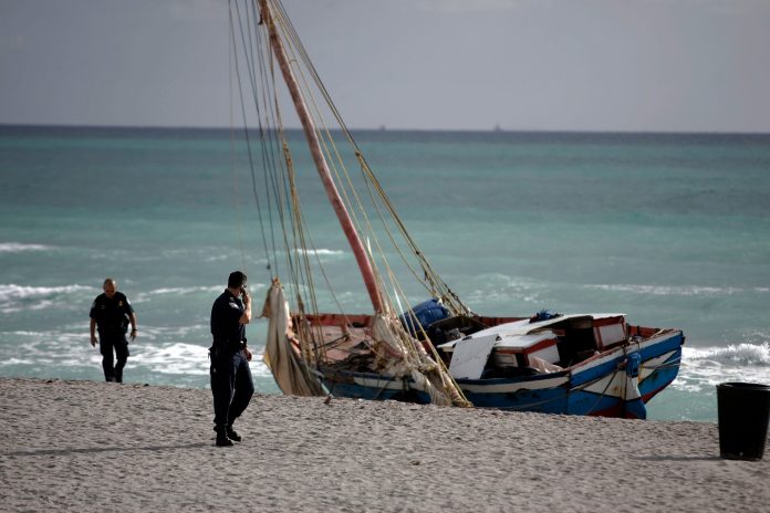 The 30- to 35-foot sailboat that carried more than 100 Haitian migrants to this beach north of Miami sits aground March 28, 2007 at Hallandale Beach, Florida. (Photo by Joe Raedle/Getty images)