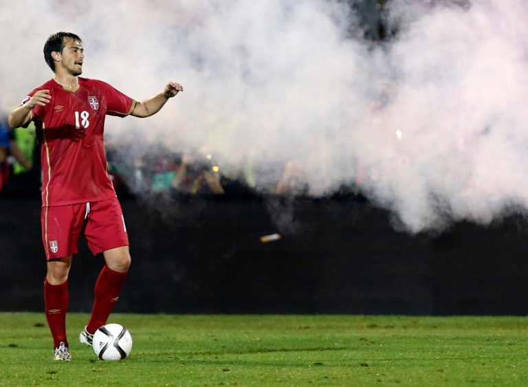 Serbia's Danko Lazovic reacts during the Euro 2016 Group I qualifying match between Serbia and Albania, at the Partizan stadium in Belgrade, Serbia, Tuesday, Oct. 14, 2014. The 2016 European Championship qualifier between Serbia and Albania was abandoned on Tuesday after skirmishes broke out on the pitch involving players and fans over an Albanian flag that was flown above the stadium by a drone. (AP Photo/Darko Vojinovic)
