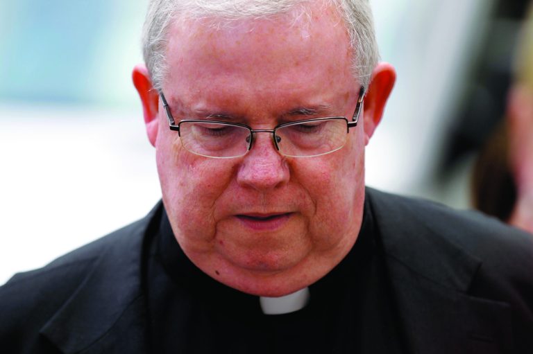 FILE - In this June 22, 2012 file photo, Monsignor William Lynn walks to the Criminal Justice Center before a scheduled verdict reading, in Philadelphia. Lynn, who became the first U.S. church official branded a felon for covering up sex abuse claims against priests was sentenced Tuesday, July 24, 2012 to three to six years in prison. (AP Photo/Matt Rourke, File)