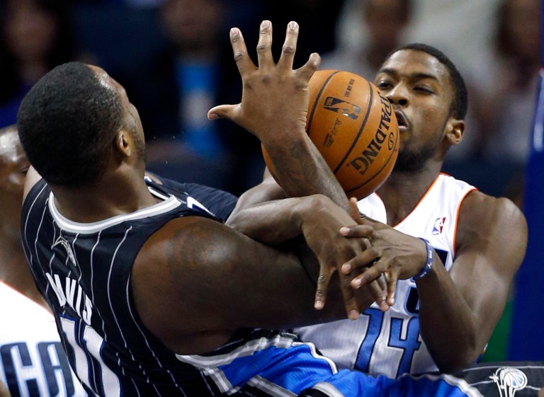   Orlando Magic's Glen Davis (11) is fouled by Charlotte Bobcats' Michael Kidd-Gilchrist (14) during the first half of an NBA basketball game in Charlotte, N.C., Saturday, Dec. 15, 2012. (AP Photo/Chuck Burton)  