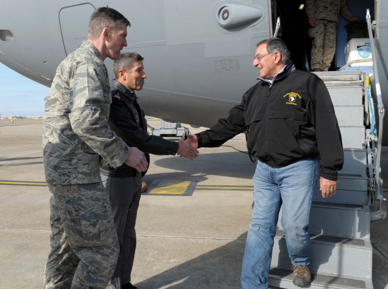   Defense Secretary Leon Panetta, right, walks off of his plane and shakes hands with 10th Tanker Base Commander Brig. Gen Serdar Gulbas, center, Col. Christopher E. Craige, at left, Commander of the 39th Air Base Wing at Incirlik Air Base, Turkey, Friday, Dec. 14, 2012. Panetta stopped to visit troops in Turkey before heading home after spending three days in Afghanistan. (AP Photo/Susan Walsh, Pool)  