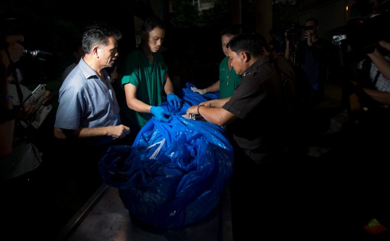 FILE - In this Tuesday, Sept. 16, 2014 file photo, the body of one of slain British tourists, Hannah Witheridge, wrapped in plastic sheet, is carried at a forensic police facility in Bangkok, Thailand. Police Maj. Gen. Kiattipong Khawsamang said Thursday, Oct. 2 that two out of three Myanmar workers questioned by police admitted murdering Witheridge, 23, and David Miller, 24. (AP Photo/Sakchai Lalit, File)