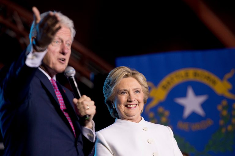Former President Bill Clinton, left, accompanied by Democratic presidential candidate Hillary Clinton, right, speaks at debate watch party at the Craig Ranch Regional Amphitheater in North Las Vegas, Wednesday, Oct. 19, 2016, following the third presidential debate. (AP Photo/Andrew Harnik)