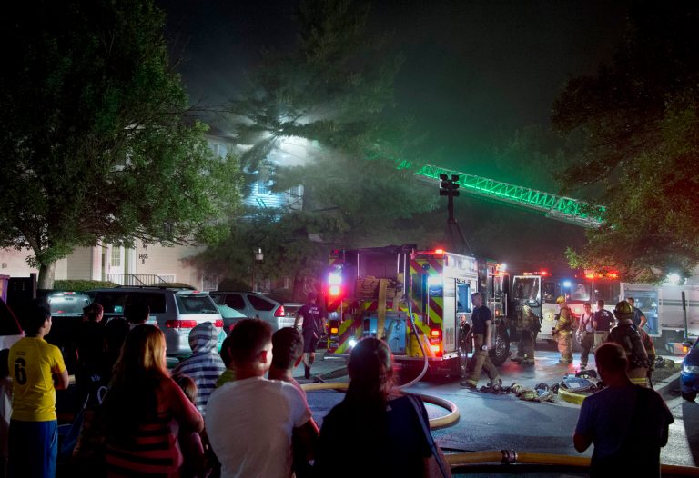 About 40 firefighters are on the scene of an apartment fire at Hickory Hill Apartments off Key Parkway in Frederick, Md., at about 2:30 a.m. Monday, Aug. 4, 2014. Ten people were hurt including a mother and her two children in critical condition taken to Children's National Medical Center in Washington. (AP Photo/The Frederick News-Post, Sam Yu)