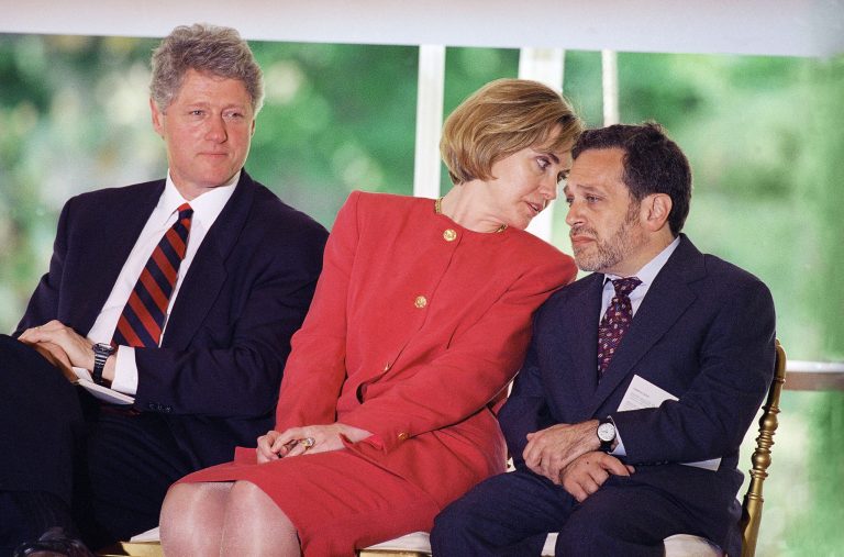 President Bill Clinton watches a ceremony to honor the signing of the Goals 2000 Educate America Act bill as first lady Hillary Rodham Clinton talks to Labor Secretary Robert Reich at the White House in Washington, May 16, 1994. (AP Photo/Joe Marquette)
